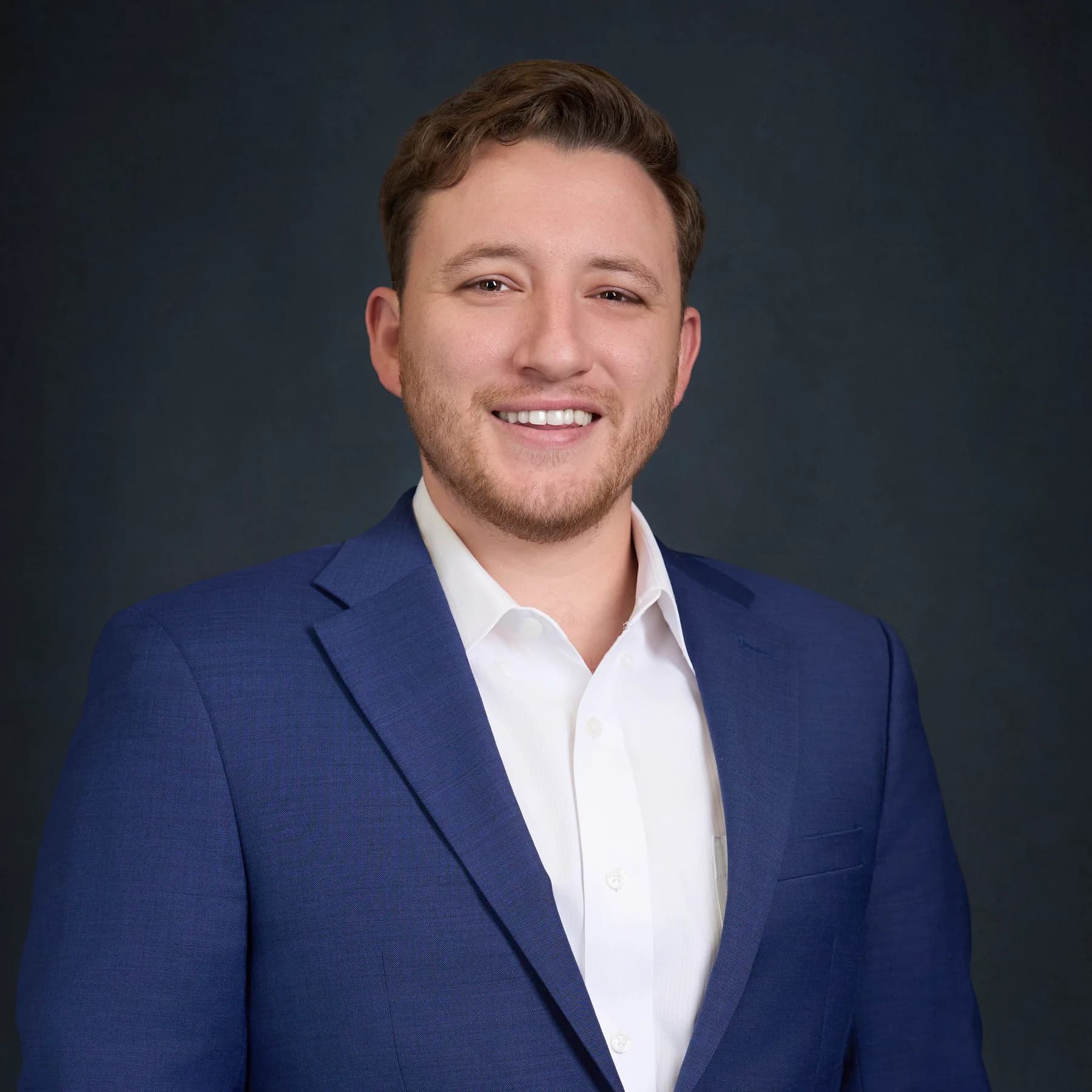 Studio portrait of Hunter Shields wearing a blue jacket and white shirt
